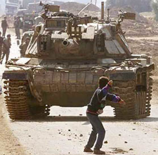 Photograph of Odeh throwing a stone at an Israeli tank in the Gaza Strip during the Second Intifada, 29 October 2000