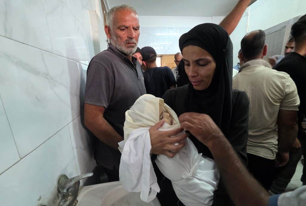 A mother’s body in Gaza was cut in half by an Israeli strike, her 1-year-old daughter’s skull split open, eyewitnesses…